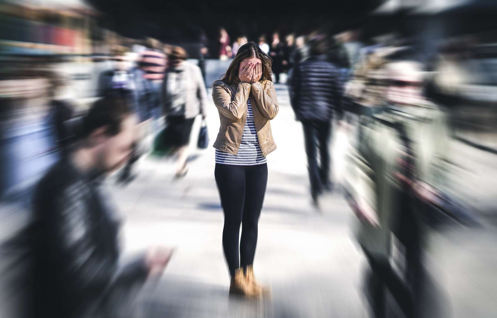 Panic attack in public place. Woman having panic disorder in city. Psychology, solitude, fear or mental health problems concept. Depressed sad person surrounded by people walking in busy street. Woman with panic attack