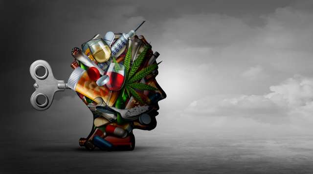 Drug Addiction And Mental Function A portrait of a human head in a sideways position, consisting of addictive substances such as drugs, a cannabis plant, etc.