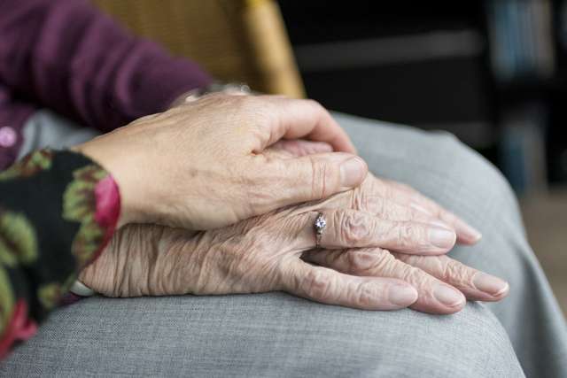 hands old age elderly vulnerable care Young hand holding hand of older person